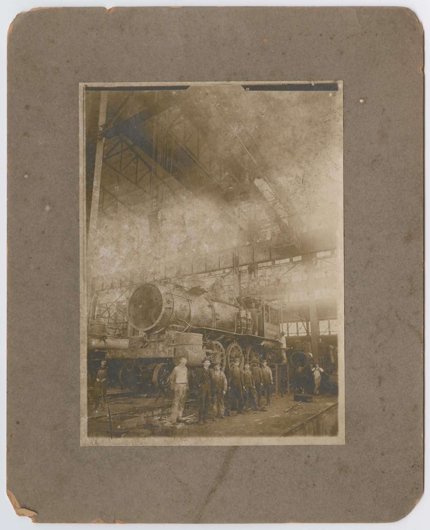 Men Beside an Unfinished Train Engine