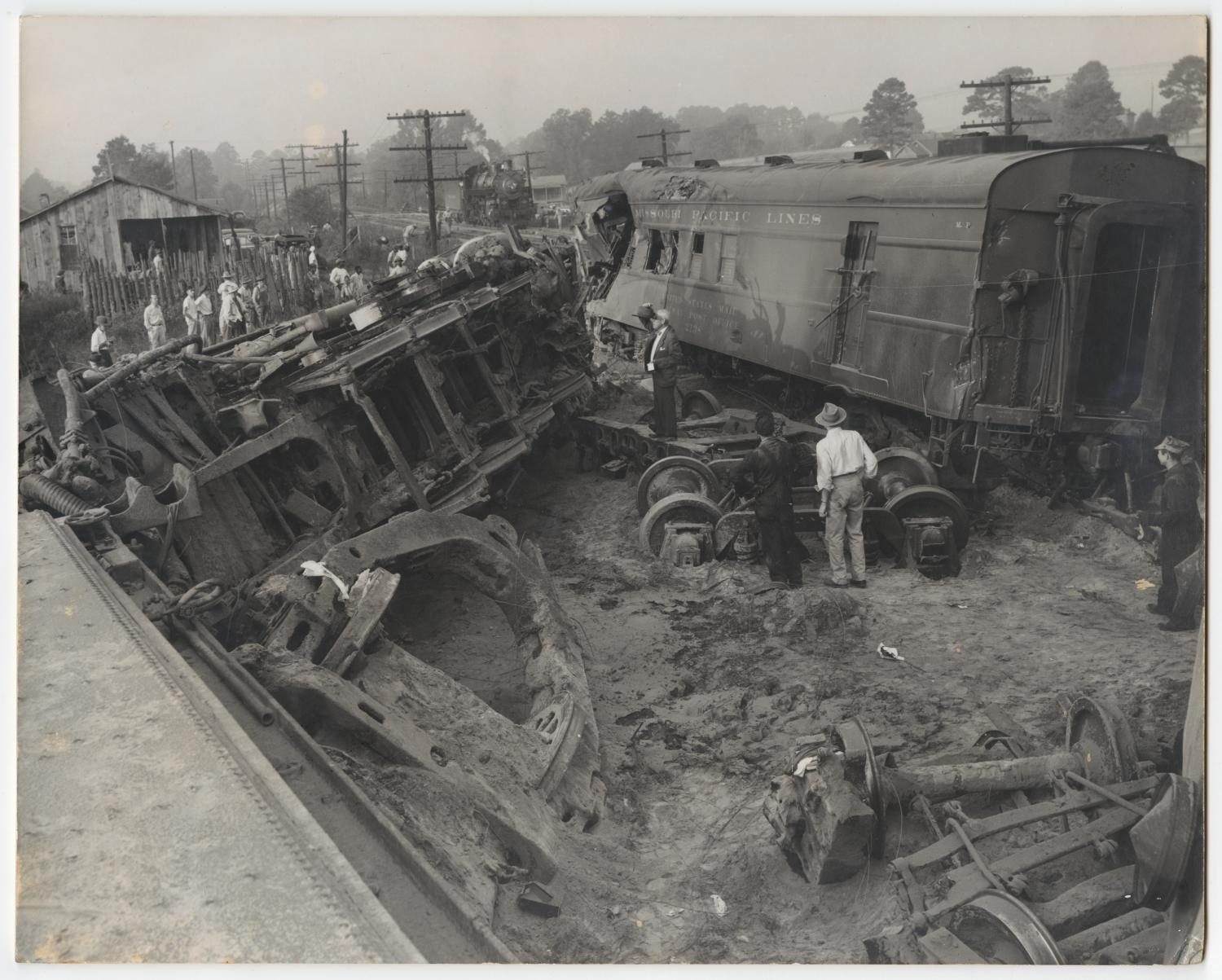 Image of Men Inspecting a Train Wreck