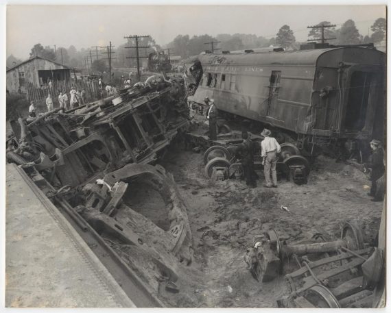 Image of Men Inspecting a Train Wreck