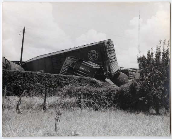 Train Wreck Behind a Hedge
