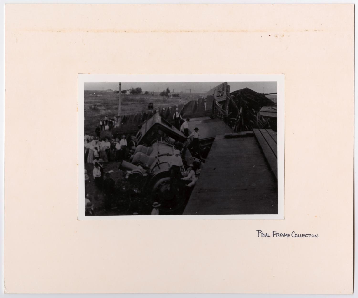 Men Crowding Around a Train Wreck