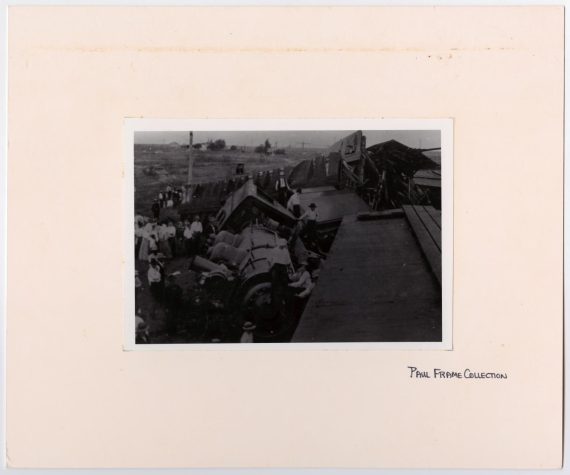 Men Crowding Around a Train Wreck
