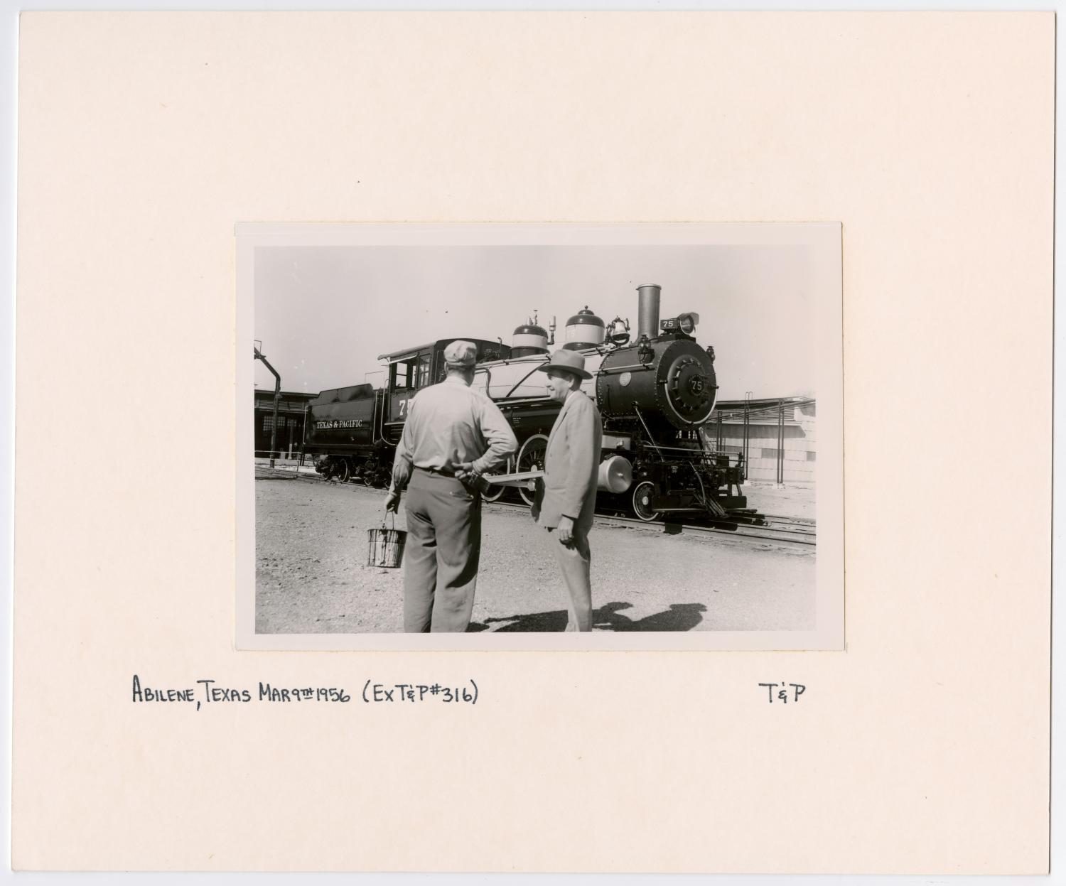 Two Men Talking in Front of Train #75