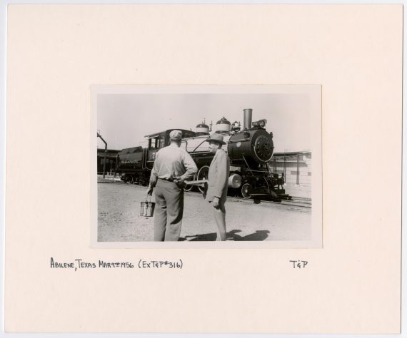 Two Men Talking in Front of Train #75