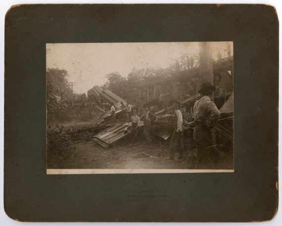 Men Inspecting Train Wreckage